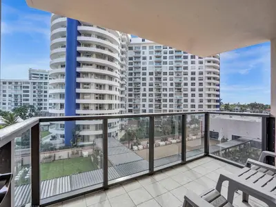 a balcony with a view of a large building at Adorable 2 Bedroom Condo Beach Service 605 in Miami Beach