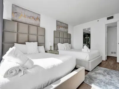 a bedroom with two beds and a couch at Adorable 2 Bedroom Condo Beach Service 605 in Miami Beach