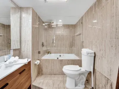 a bathroom with a toilet and a tub and a sink at Amazing Ocean View Condo Beach Service 607 in Miami Beach