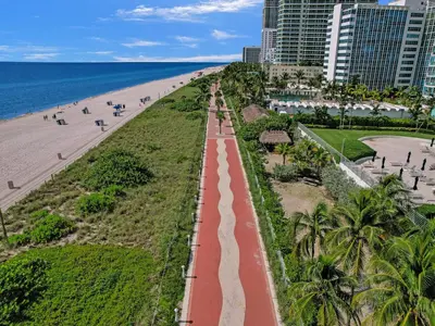 an aerial view of a beach with palm trees and buildings at Amazing Ocean View Condo Beach Service 607 in Miami Beach