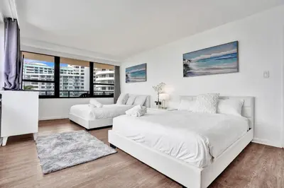 a white bedroom with a large bed and a couch at Spacious Ocean View Resort Beach Condo 601 in Miami Beach