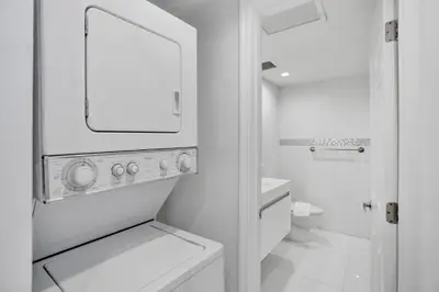 a white bathroom with a sink and a mirror at 2BR 2BA condo with beach service 1616 in Miami Beach