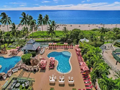 an aerial view of a resort with a pool and the beach at 2BR 2BA condo with beach service 1616 in Miami Beach
