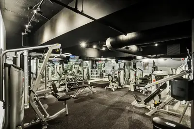 a gym with a lot of equipment in it at 2BR 2BA condo with beach service 1616 in Miami Beach