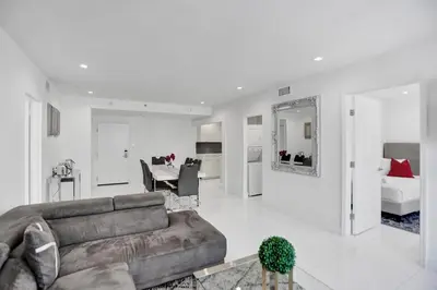 a living room with a couch and a dining room at 2BR 2BA condo with beach service 1616 in Miami Beach