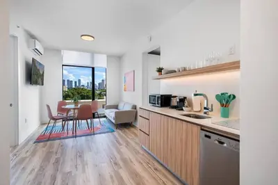 a kitchen and living room with a table and chairs at Pastel Apartments in Miami