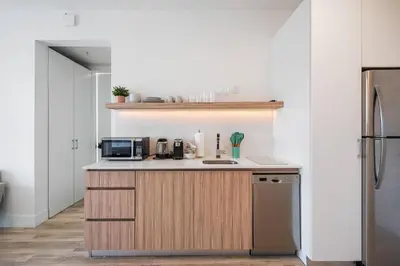 a kitchen with a counter with a microwave and a refrigerator at Pastel Apartments in Miami