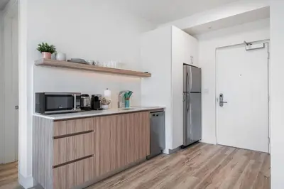 a kitchen with a microwave and a refrigerator at Pastel Apartments in Miami