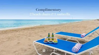 a picnic table on the beach with drinks and food at Resort Near Beach with Amazing Pool and Gym in Hallandale Beach