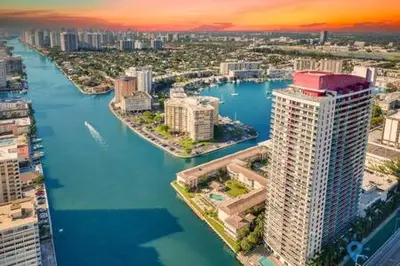 an aerial view of a city with a river and buildings at Beachwalk - Sun, Amazing Pools and Gym in Hallandale Beach
