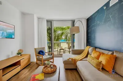 a living room with a couch and a table at Apartment with Balcony - Pool- Near Beach in Hallandale Beach