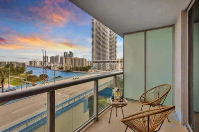 a balcony with chairs and a view of the city at Spectacular Apartment with Balcony Near Beach in Hallandale Beach