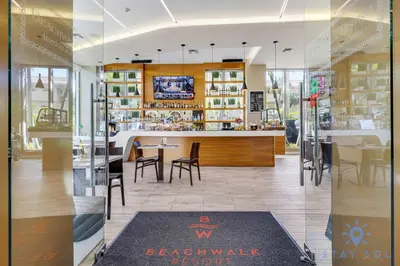a restaurant with a counter and tables and chairs at Spectacular Apartment with Balcony Near Beach in Hallandale Beach