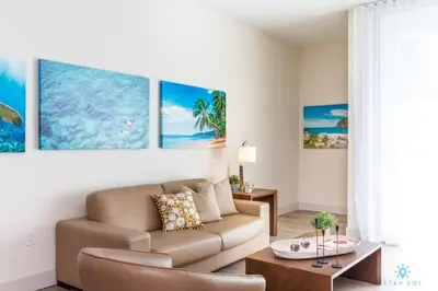 a living room with a couch and a table at Best Stay Rooftop Pool Hollywood Beach Boardwalk in Hollywood