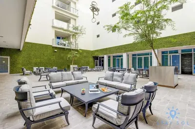 a patio with couches and chairs and a table at Worth Traveling Hot tub & Unique Rooftop pool in Hollywood