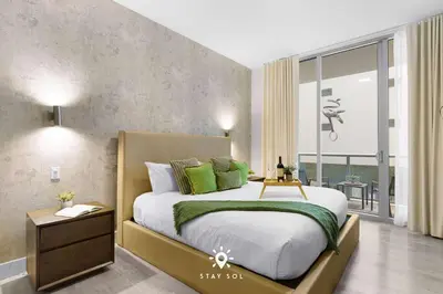 a bedroom with a large bed and a large window at Worth Traveling Hot tub & Unique Rooftop pool in Hollywood