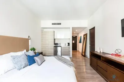 a bedroom with a large white bed with blue pillows at The Most Liked Homes Hot tub & Unique Rooftop in Hollywood