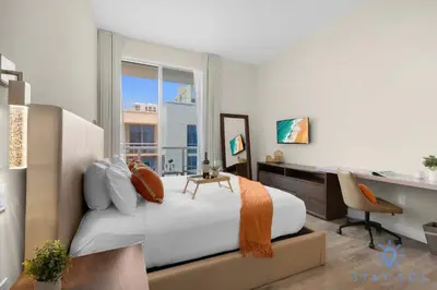 a bedroom with a bed and a desk and a window at Hot tub & Unique Rooftop-Hollywood Broad-walk in Hollywood