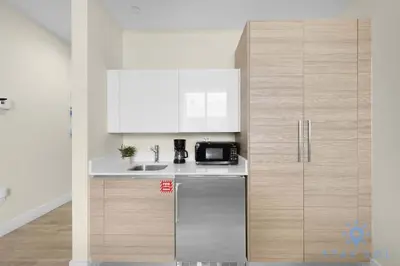 a kitchen with a stainless steel refrigerator and a microwave at Hot tub & Unique Rooftop-Hollywood Broad-walk in Hollywood