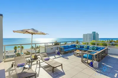 a balcony with a view of the beach at Hot tub & Unique Rooftop-Hollywood Broad-walk in Hollywood