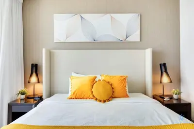 a bedroom with a large white bed with orange pillows at Awesome Ocean View and Amenities, Pools - 2 BR in Hollywood