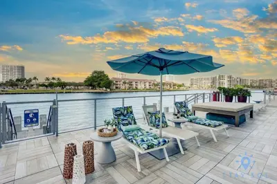 a patio with a table and chairs and an umbrella at Breathtaking Front Ocean View: Amazing Pools in Hollywood