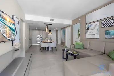 a living room with a couch and a dining room at Breathtaking Front Ocean View: Amazing Pools in Hollywood
