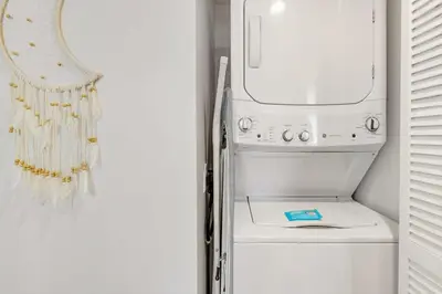 a white refrigerator with a washing machine in a room at Beachfront Resort Pool Ocean View Balcony Gym in Aventura