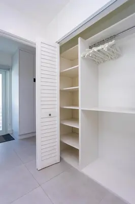 a white walk in closet with white shelves at WALK to Hollywood Beach Spectacular 5BR and 5BA Villa in Hollywood