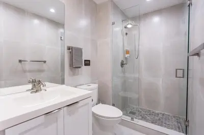 a bathroom with a toilet sink and a shower at WALK to Hollywood Beach Spectacular 5BR and 5BA Villa in Hollywood