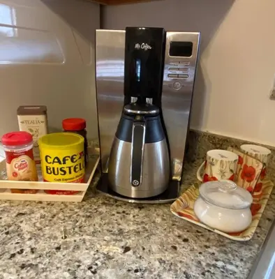 a coffee maker sitting on a kitchen counter next to a counter top at Judit’s in Dania in Dania Beach
