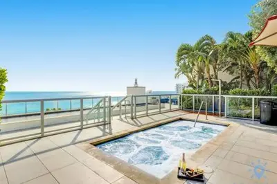 a hot tub on a patio next to the ocean at Condo Bay View Infinity Pool Beach Service in Hollywood
