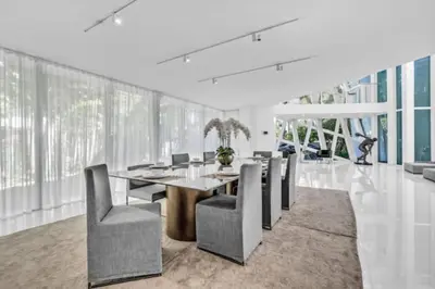 a dining room with a table and chairs at Villa Loggia Oasis Luxurious 6BD ,7BA with Resort Style Pool in Golden Beach