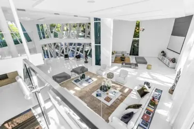 a living room with white furniture and windows at Villa Loggia Oasis Luxurious 6BD ,7BA with Resort Style Pool in Golden Beach