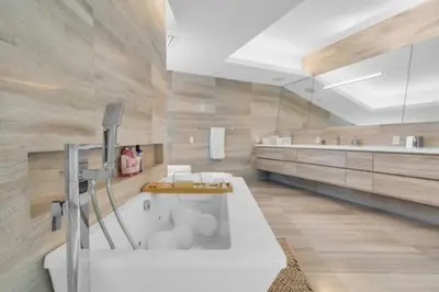a large bathroom with a tub and a sink at Villa Loggia Oasis Luxurious 6BD ,7BA with Resort Style Pool in Golden Beach