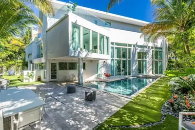 an exterior view of a house with a swimming pool at Villa Loggia Oasis Luxurious 6BD ,7BA with Resort Style Pool in Golden Beach