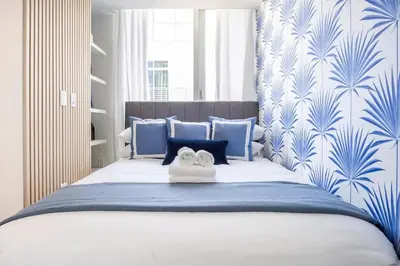 a bedroom with a blue and white bed with a towel at Boutique Condo in DT Miami Perfect for Couples/Fam in Miami