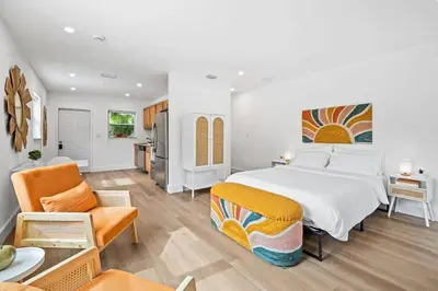 a bedroom with a large bed and a living room at Morning Sunshine @Sailboat Bend in Fort Lauderdale