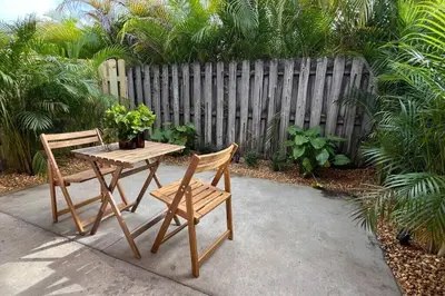 a table and two chairs and a table and a fence at Morning Sunshine @Sailboat Bend in Fort Lauderdale