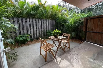 a patio with a table and chairs and a fence at Morning Sunshine @Sailboat Bend in Fort Lauderdale