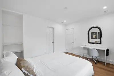 a white bedroom with a desk and a bed at Sailors Rest @ Sailboat Bend in Fort Lauderdale