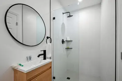 a white bathroom with a sink and a mirror at Spacious 2 BR @Sailboat Bend in Fort Lauderdale