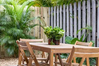 a wooden table with chairs and a potted plant on it at Spacious 2 BR @Sailboat Bend in Fort Lauderdale