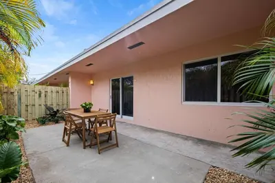 a patio with a table and chairs in front of a house at Spacious 2 BR @Sailboat Bend in Fort Lauderdale