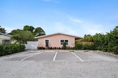 a pink house with a parking lot at Spacious 2 BR @Sailboat Bend in Fort Lauderdale