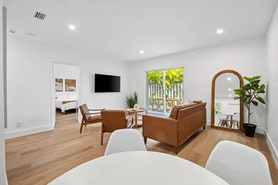 a living room with a table and chairs and a mirror at Spacious 2 BR @Sailboat Bend in Fort Lauderdale