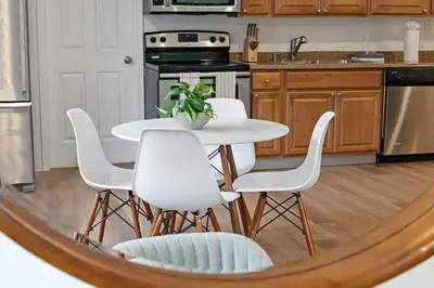 a kitchen with a white table and white chairs at Awesome 1BR Apartment @Sailboat in Fort Lauderdale
