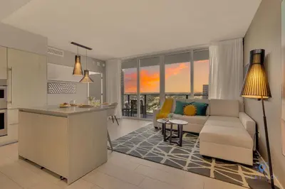 a kitchen and living room with a couch and a table at Beach House Design in Hollywood