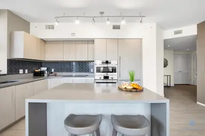 a kitchen with a large island with two bar stools at Very Chic - Bay View & Balcony - Amazing Pools- Gym in Hollywood