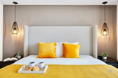 a bed with yellow pillows and a tray of donuts on it at Very Chic - Bay View & Balcony - Amazing Pools- Gym in Hollywood